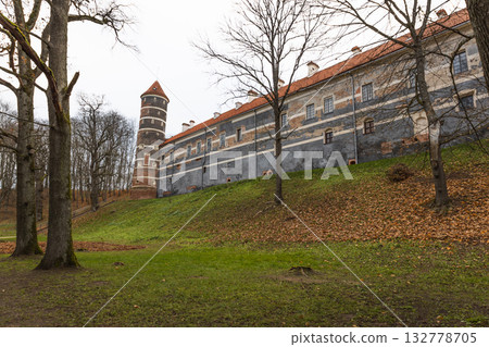 Historic hillside monastery with bell tower and long facade above a quiet park 132778705