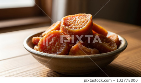 Bowl of Dried Sweet Potato Rounds on Wooden Table 132778800