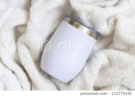 White blank Stainless Steel wine tumbler on cream knitted plaid top view, Christmas mockup 132779185