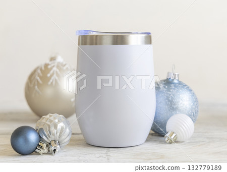 White blank Stainless Steel wine tumbler near beige and light blue Christmas baubles closeup, mockup White blank Stainless Steel wine tumbler near beige and light blue Christmas baubles closeup, mockup 132779189