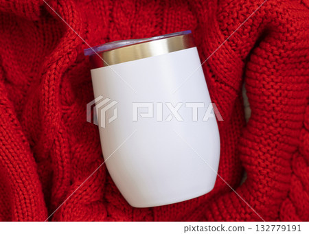 White blank Stainless Steel wine tumbler on red knitted sweater top view, Christmas mockup White blank Stainless Steel wine tumbler on red knitted sweater top view, Christmas mockup 132779191