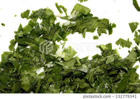 Close up of chopped coriander and parsley herbs on a white background 132779341