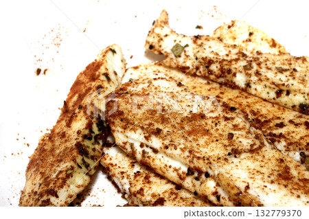 Close up of seasoned halloumi cheese ready to be grilled on white background 132779370