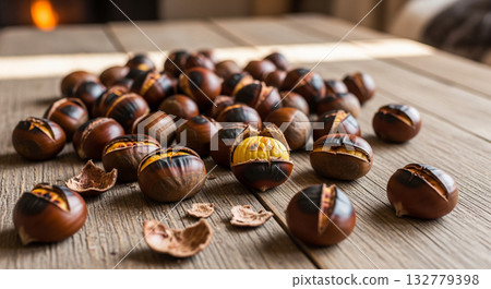 Scattered Roasted Chestnuts on Wooden Table 132779398