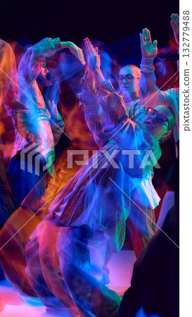 Dancers in dynamic neon motion blur celebrating movement Dancers in dynamic neon motion blur celebrating movement 132779488