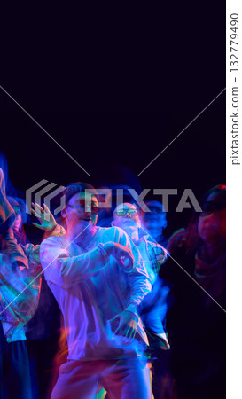 Neon motion blur captures dancers in energetic street performance Neon motion blur captures dancers in energetic street performance 132779490