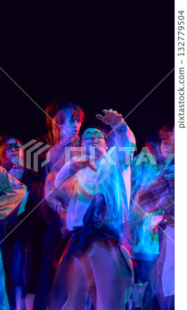 Hip hop dancers performing in colorful motion blur light 132779504
