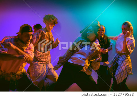 Group of street dancers moving in colorful motion blur Group of street dancers moving in colorful motion blur 132779558