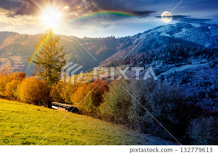 autumn equinox in mountain landscape. day and night time change concept. beautiful view of trees in fall foliage on the hillside with sun and moon at twilight. alps of countryside under dramatic sky 132779613