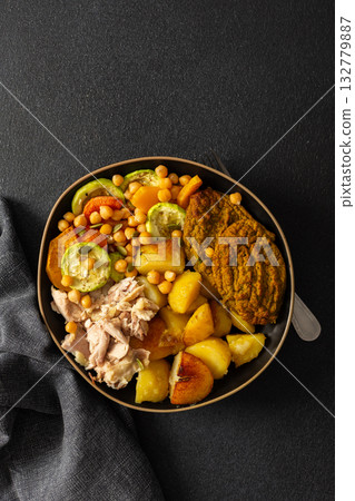 This balanced breakfast showcases baked sweet potato with carrots and zucchini, flavorful carrot and lentil cutlets, chicken breast 132779887