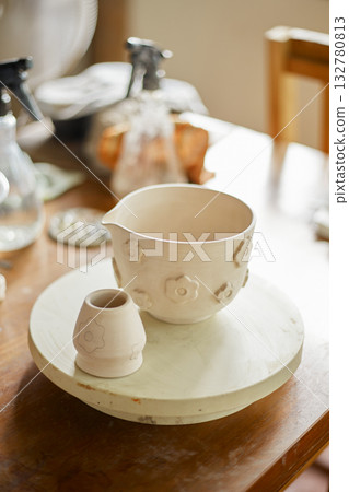 Close up hand of woman painting her pottery ceramic Close up hand of woman painting her pottery ceramic 132780813