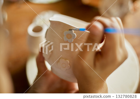 Close up hand of woman painting her pottery ceramic 132780828