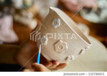 Close up hand of woman painting her pottery ceramic 132780831