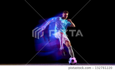 Soccer player leaping for powerful header with neon light motion 132781220
