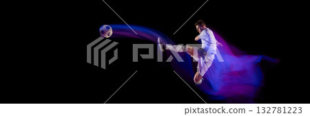 Football player performing kick with ball trajectory motion blur. Banner 132781223