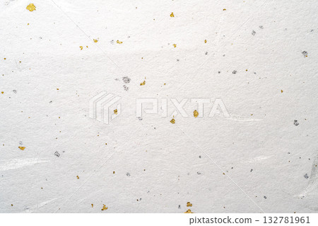A background of Japanese paper with gold and silver fibers scattered throughout 132781961