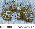 Gingerbread cookies decorated with royal icing on white knitted background, holidays greeting card 132782547