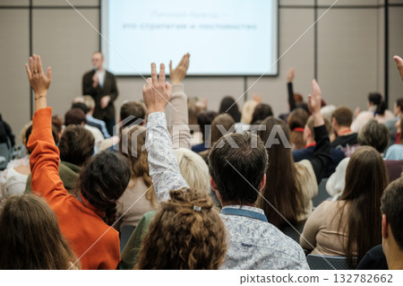 Audience participates in conference as speaker presents signaling engagement learning and collaboration Audience participates in conference as speaker presents signaling engagement learning and collaboration 132782662