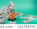 A piggy bank overflowing with cash, symbolizing saving and investment against a teal background. 132784541