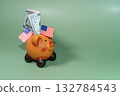 A piggy bank with American flags symbolizes savings and the US economy during a financial crisis. 132784543