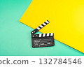 A movie clapperboard on a colorful background, ready for action in a vibrant and creative scene. 132784546