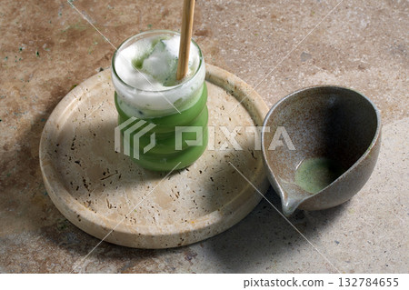 Matcha Latte Still Life. A refreshing matcha latte served with ceramic dishware Matcha Latte Still Life. A refreshing matcha latte served with ceramic dishware 132784655