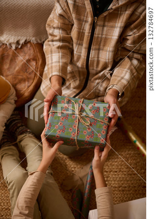 Cozy Gift Exchange Between Friends During A Warm Winter Holiday Gathering Cozy Gift Exchange Between Friends During A Warm Winter Holiday Gathering 132784697