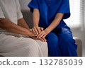 Adult Asian nurse caregiver hands provide comfort support to older Asian patient hands in healthcare medical senior living facility 132785039