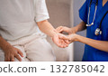 Asian nurse checks older patient pulse medical examination home care senior health assistance wellness checkup professional nursing service 132785042