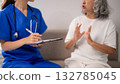 Asian nurse providing nursing care adult patient home consultation medical health service elderly woman explaining condition healthcare support 132785045