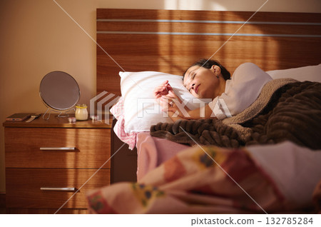 Sleeping Woman Resting In Bed At Night With Cozy Blanket And Wooden Headboard 132785284