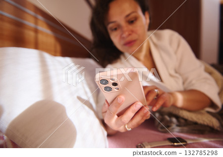 Woman Relaxing in Bed Using Smartphone at Home Woman Relaxing in Bed Using Smartphone at Home 132785298