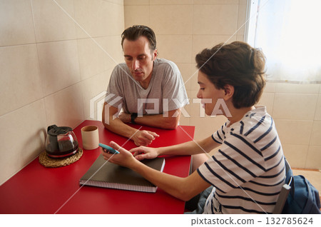 Casual Meeting At Red Table Between Friends With Phone And Notebook Casual Meeting At Red Table Between Friends With Phone And Notebook 132785624