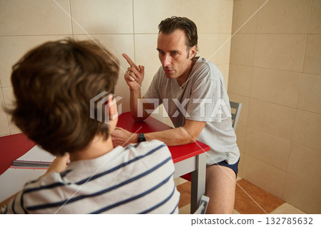 Casual Conversation Between Two Men At A Red Table In A Tiled Room 132785632