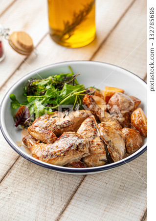Grilled chicken wings with salad on white plate Grilled chicken wings with salad on white plate 132785686