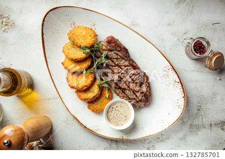 Grilled steak with hash browns and sauce Grilled steak with hash browns and sauce 132785701