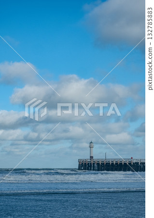 seaside lighthouse guides turbulent waters, ocean sentinel standing tall against lively waves seaside lighthouse guides turbulent waters, ocean sentinel standing tall against lively waves 132785883
