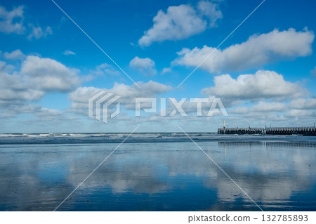 Quiet waters showcase symmetrical scene with subtle clouds Quiet waters showcase symmetrical scene with subtle clouds 132785893