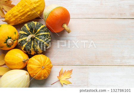 Autumn harvest gourds and pumpkins on wood background 132786101