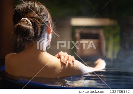 A woman entering a hot spring A woman entering a hot spring 132786582