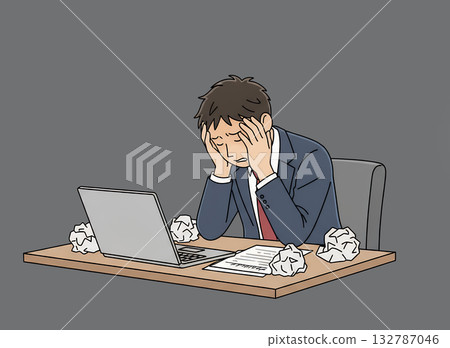 A young businessman holding his head in front of a computer 132787046