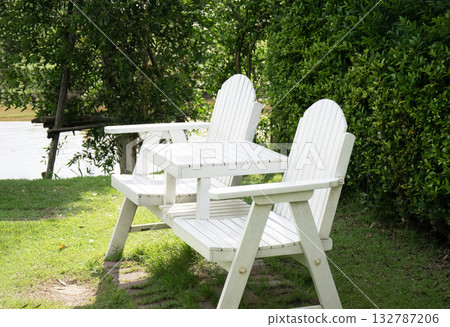 White bench in the garden White bench in the garden 132787206