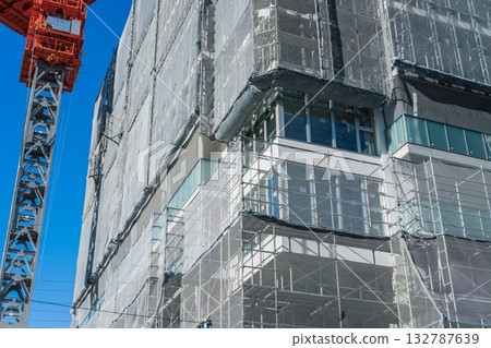 Crane and condominium construction site 132787639