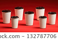 White coffee cups with black lids on red 132787706