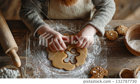 Little hands cutting shapes for Christmas cookies 132787730
