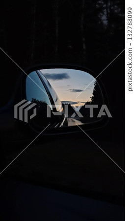 Vertical. Sunset rearview road. Driving a car on a highway at dusk. Vertical. Sunset rearview road. Driving a car on a highway at dusk. 132788099