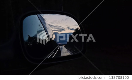 Sunset rearview road. Driving a car on a highway at dusk. Sunset rearview road. Driving a car on a highway at dusk. 132788100