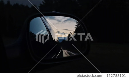 Sunset rearview road. Driving a car on a highway at dusk. Sunset rearview road. Driving a car on a highway at dusk. 132788101
