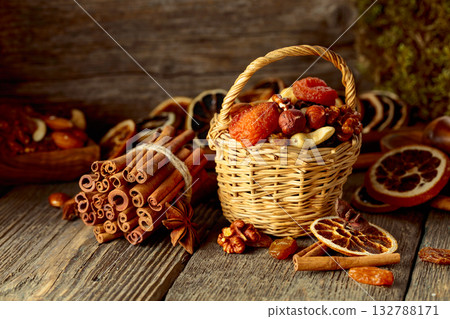 Dried fruits and nuts on an old wooden table. Dried fruits and nuts on an old wooden table. 132788171