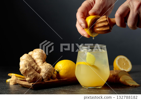 Ginger Ale with ice and lemon on a black background. Ginger Ale with ice and lemon on a black background. 132788182